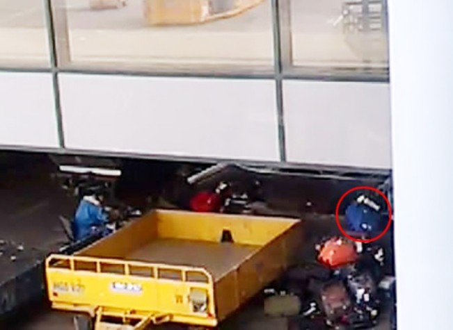 Hành lý của hành khách bị nhân viên bốc xếp ném không thương tiếc. Ảnh chụp từ clip.