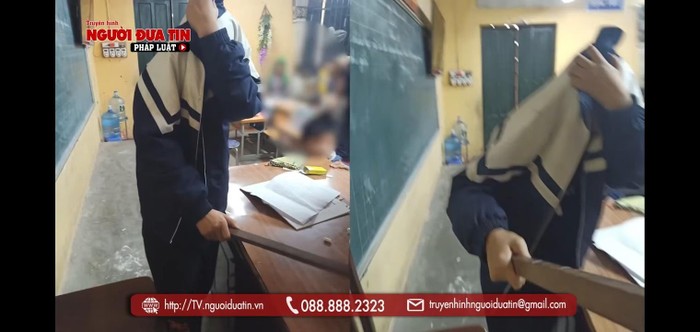 Học sinh cầm thanh gỗ lên bàn đánh cô giáo (Ảnh chụp clip Báo Người đưa tin)