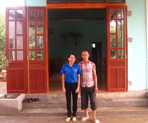 Hiếu với bạn Đào Thị Hiền (Phó Bí thư Đoàn xã Đức Dũng) chụp ảnh trước ngôi nhà vừa xây xong (Ảnh: Lê Văn Vỵ)