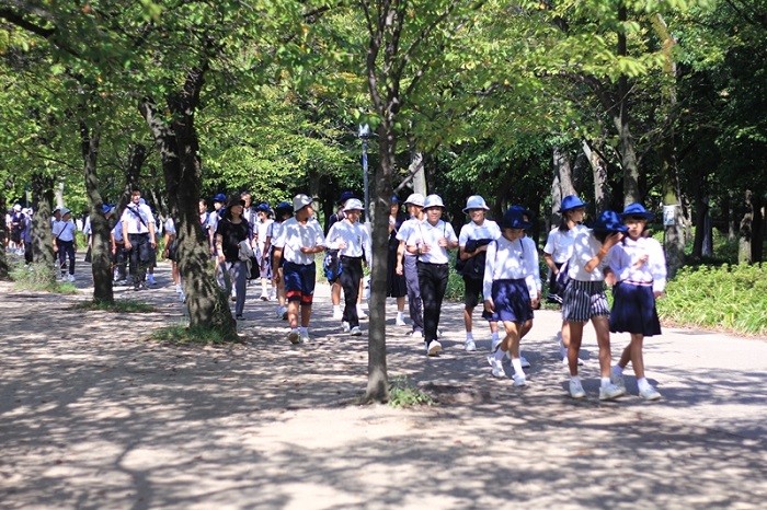 Học sinh thường mặc đồng phục, đầu đội mũ “Totto-chan” đủ màu của mỗi trường khi đi ngoại khóa. Đây cũng là cách giúp thầy cô dễ kiểm soát và bạn bè cùng trường dễ nhận biết nhau trong đám đông. Cứ hai người một hàng đi với nhau vô cùng trật tự.
