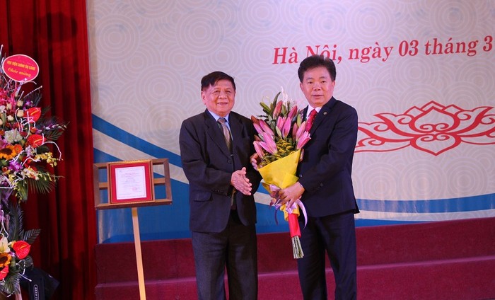 Phó Chủ tịch Hiệp hội Các trường đại học, cao đẳng Việt Nam- PGS.Trần Xuân Nhĩ tặng hoa chúc mừng Học viện Tài chính
