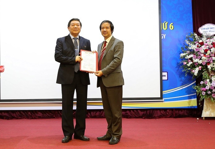 Giám đốc Đại học Quốc gia Hà Nội Nguyễn Kim Sơn (phải) trao quyết định bổ nhiệm lại cho Giám đốc Nguyễn Quốc Anh.