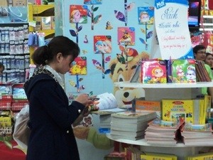 Phụ huynh chọn sách cho con tại siêu thị Big C Thăng Long. (Ảnh: Tâm Tâm/Vietnam+)