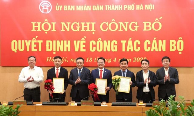 Chủ tịch Ủy ban nhân dân thành phố Hà Nội trao quyết định và chúc mừng các cán bộ được điều động, bổ nhiệm giữ chức vụ mới.