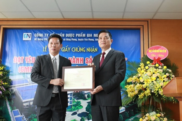 Cục trưởng Nguyễn Thanh Phong trao giấy chứng nhận là cơ sở đầu tiên đạt yêu cầu về thực hành sản xuất GMP thực phẩm bảo vệ sức khỏe cho đơn vị đầu tiên đạt yêu cầu. Ảnh: Gia Nguyễn