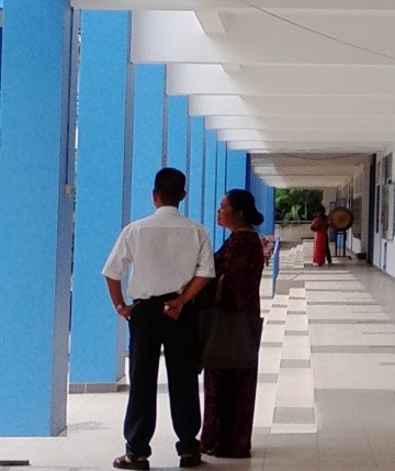 Cô Đào Thị Kim Nhi - Hiệu trưởng đang đứng nói chuyện với một giám thị trong trường.