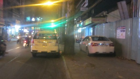 Hai ô tô đậu trên vỉa hè, dưới lòng đường cùng 1 lúc, trong đó có 1 taxi (ảnh: P.L)