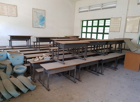Một phòng học còn đầy đủ bàn ghế, nhưng bám đầy bụi chứng tỏ đã lâu không ai sử dụng (ảnh: P.L)