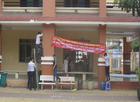 Giáo viên chuẩn bị cho việc treo băng rôn trong Trường Trần Quang Khải, quận 11 (ảnh: P.L)