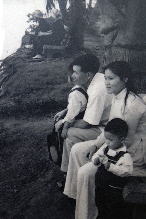 Hai cậu bé quây quần bên bố mẹ trên một chiếc ghế đá bên bờ Hồ trong những ngày bình lặng của Hà Nội năm 1972.
