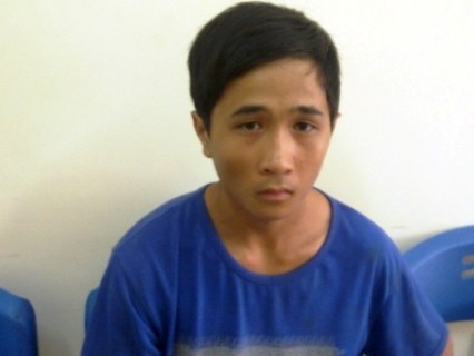 Sát thủ nhí Phan Xuân Quang sau khi bị bắt giữ.