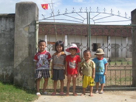 Những em học sinh tiểu học khối Văn Hà đứng trước cổng điểm trường của khối vì không được bố mẹ cho đến trường