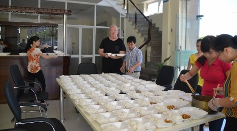 Từ 6 giờ sáng các tình nguyện viên, giáo viên Trường ĐH Công nghiệp Vinh đã tập trung chuẩn bị các suất ăn miễn phí cho các thí sinh và người nhà (ảnh Xuân Hòa)