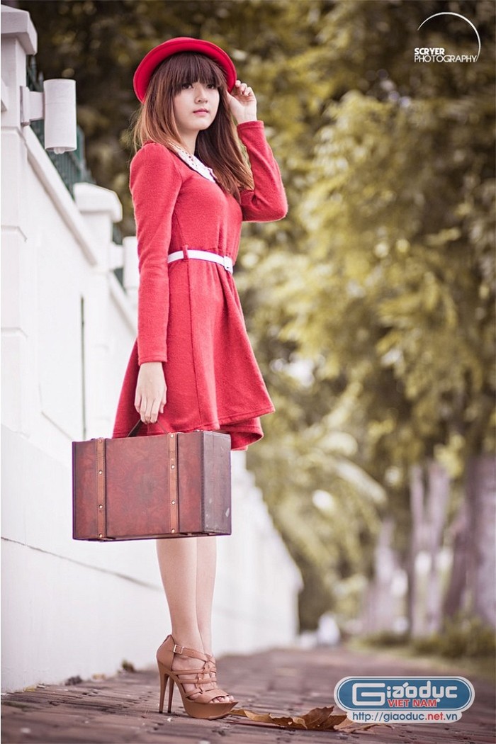 Chiếc váy liền thân màu đỏ tươi tắn, nổi bật cổ ren trắng mix cùng thắt lưng bản nhỏ tạo nét trẻ trung, đáng yêu