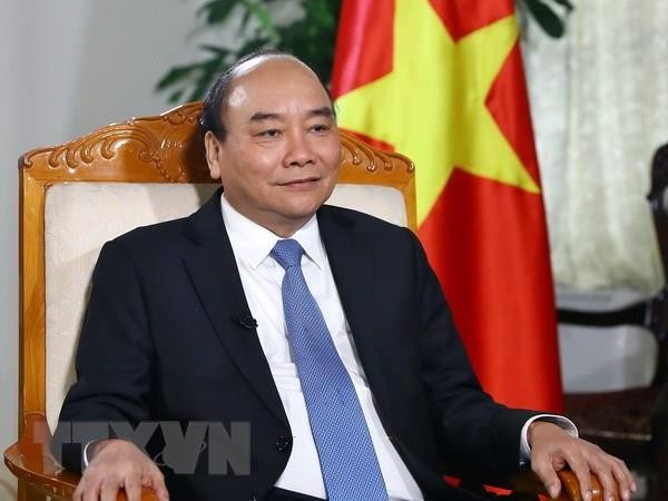 Thủ tướng Chính phủ Nguyễn Xuân Phúc trả lời phỏng vấn báo chí. Ảnh: TTXVN