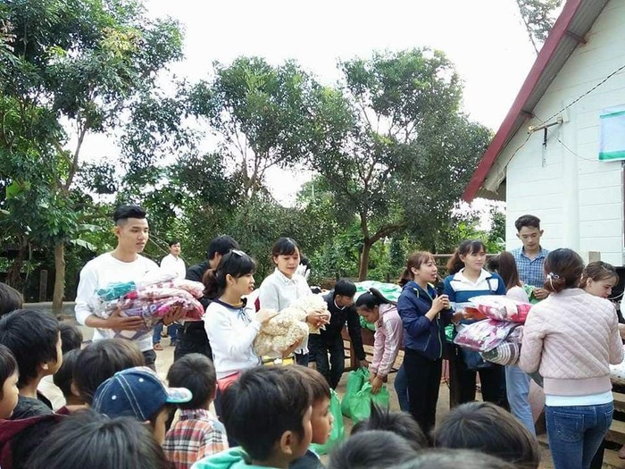 Cô Hà Thị Mai Hương (cầm micro) cùng các giáo viên, tình nguyện viên tặng quà cho học trò nghèo