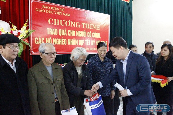 Nhà báo Nguyễn Tiến Bình tặng quà Tết cho các gia đình có hoàn cảnh khó khăn. Ảnh: Tùng Dương