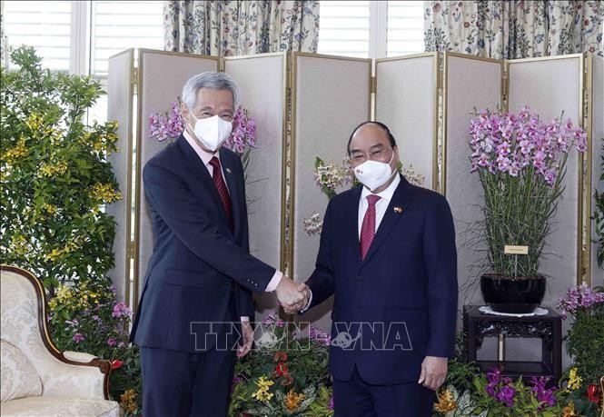 Chủ tịch nước Nguyễn Xuân Phúc gặp Thủ tướng Singapore Lý Hiển Long. Ảnh: Thống Nhất/ TTXVN