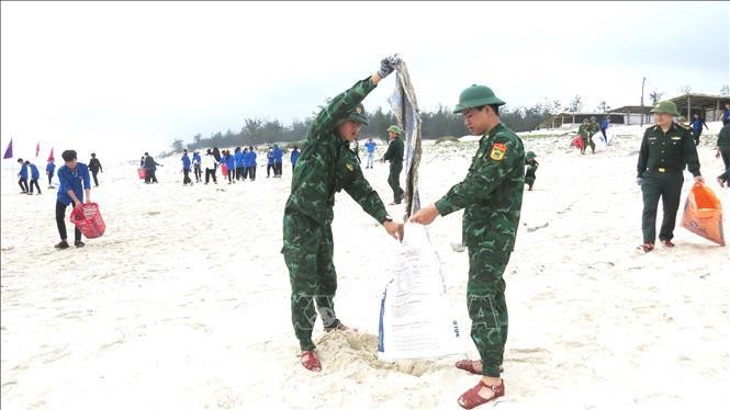 Đoàn viên thanh niên Bộ đội Biên phòng tỉnh Quảng Bình vệ sinh môi trường, làm sạch bãi biển. Ảnh tư liệu: Võ Dung/TTXVN