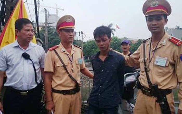 Đại úy Nguyễn Anh Tuấn và Trung úy Nguyễn Mậu Trung đang áp giải tên cướp về trụ sở công an phường