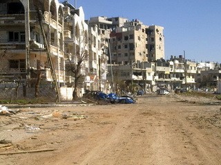 Khung cảnh hoang tàn của thành phố Homs - Ảnh: AFP