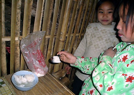 hơn nữa thì ăn cơm nguội với nước lã, rắc vài hạt muối trắng. Bữa ăn của em Lý Thị Mỵ - HS trường phổ thông cơ sở Thái Sơn.