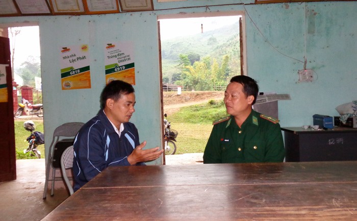 Anh Đồng Quang Khanh (trái) đang trao đổi công việc với chiến sĩ biên phòng đồn biên phòng cửa khẩu Lóng Sập