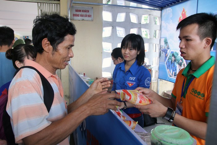 Tại các bến xe Hà Nội, lực lượng sinh viên tình nguyện triển khai giúp đỡ sĩ tử, người nhà, góp phần nào xua đi nỗi lo. Trong ảnh là người nhà sĩ tử nhận bánh mỳ miễn phí tại Bến xe phía Nam.