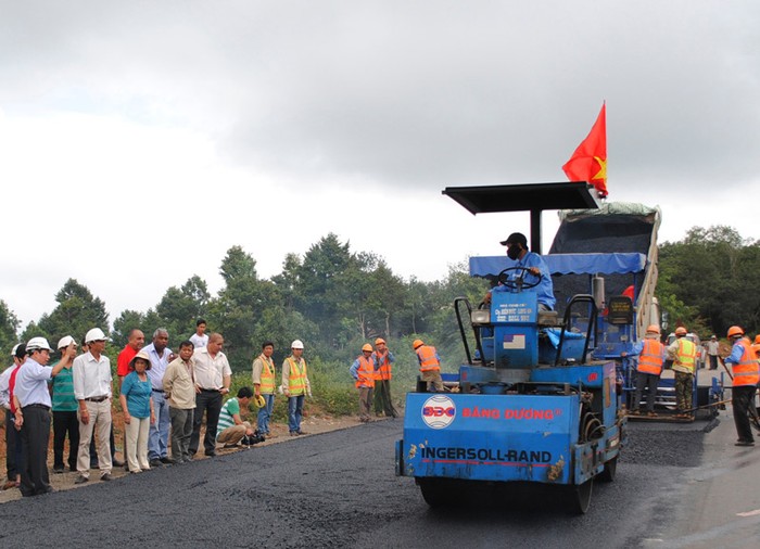 Ông Nguyễn Văn Huấn, Phó tổng giám đốc Ban Quản lý dự án đường HCM (bìa trái đang chỉ tay) đánh giá cao công tác tưới nhựa ngay sau khi mùa khô vừa đến của dự án BOT Toàn Mỹ 14, đã đi tiên phong trên QL14 qua Tây Nguyên.