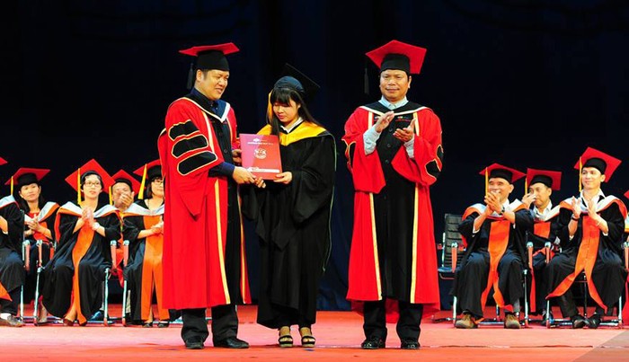 Hiệu trưởng Đàm Quang Minh trao bằng tốt nghiệp cho các tân kĩ sư Công nghệ thông tin.