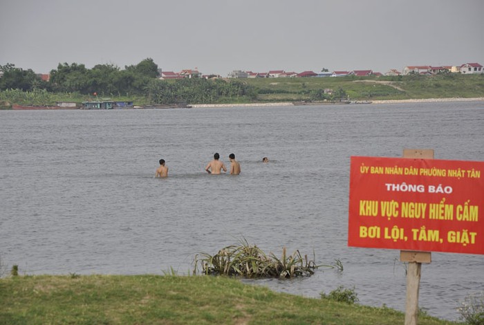 Biển cấm không phát huy được tác dụng khi nhiều người vẫn hồn nhiên bơi lội trên khu vực này.