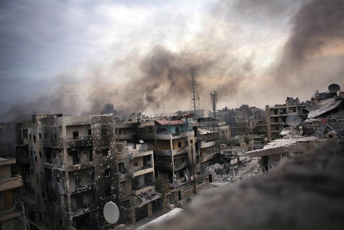 Những cột khói bốc lên trên những tòa nhà đổ nát ở quận Saif al Dawle, Aleppo, Syria ngày 02/10. Quân đội Syria đã tiếp tục pháo kích thành phố này nhằm dập tắt sự kháng cự của phe nổi dậy.