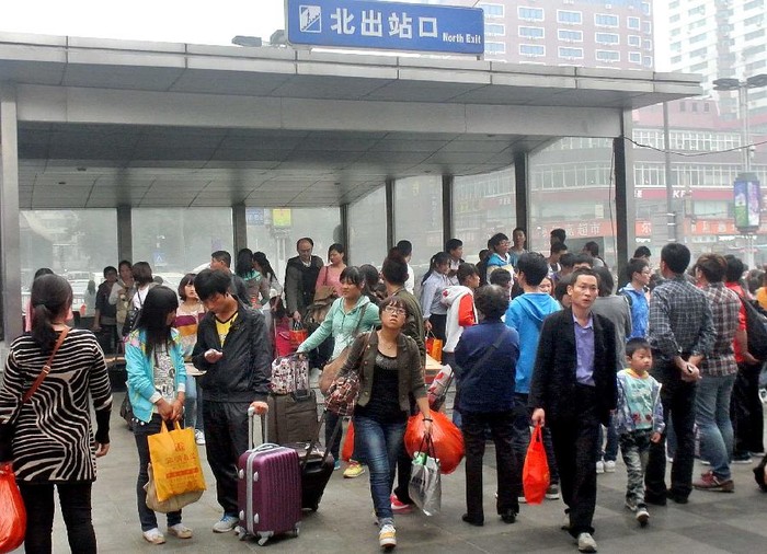 Rất đông hành khách tay xách nách mang lũ lượt kéo ra ga xe lửa Trịnh Châu