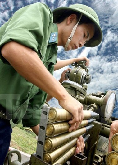 Chiến sĩ pháo cao xạ của Sư đoàn Phòng không Bắc Thái nạp đạn chuẩn bị bắn.