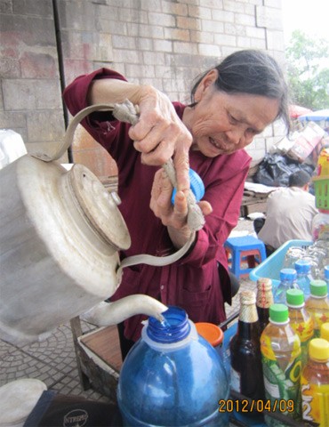 Bà Hiền năm nay đã 79 tuổi. Bà sống bằng nghề bán nước ngay dưới chân cầu. Ở đây, khách chủ yếu là người đến thu mua đồng nát, đi xe ôm. Họ ra uống nước cho bà đắt hàng.