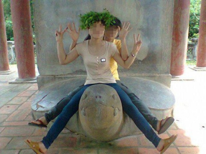 Hai nữ sinh tạo dáng thoải mái khi cưỡi lên cổ cụ rùa
