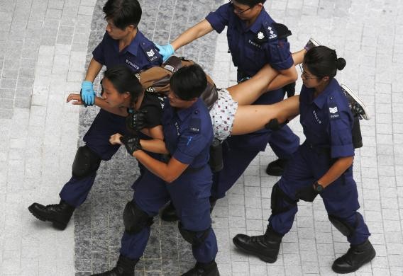Một nữ sinh tham gia biểu tình bị cảnh sát Hồng Kông bắt giữ và khiêng đi.