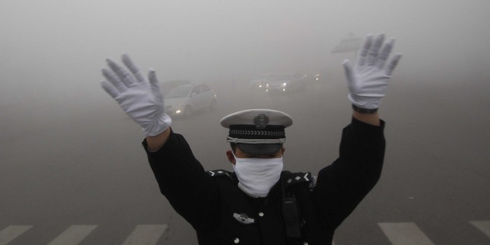 Một cảnh sát giao thông Bắc Kinh phải đeo khẩu trang làm việc vì không khí quá ô nhiễm.