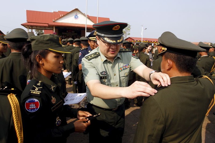 Một viên Trung tá Trung Quốc gắn quân hàm sĩ quan cho học viên quân sự Campuchia. Ảnh: Euronews.