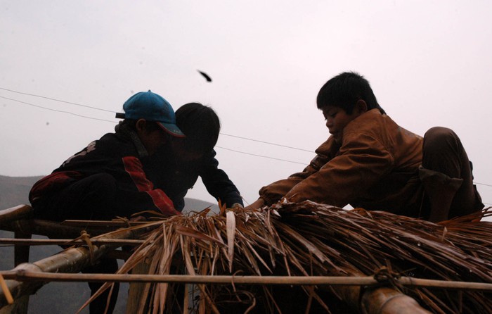 Các em học sinh ở Mù Căng Chải (Yên Bái) phải lên rừng tìm tre nứa, tự tay lớp mái lớp học như những người thợ lành nghề