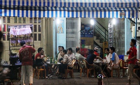 Trời đã khuya các ông vẫn "ngồi đồng" ở một quán nhậu trên đường Thành Thái, TP HCM. Ảnh: Thi Trân.