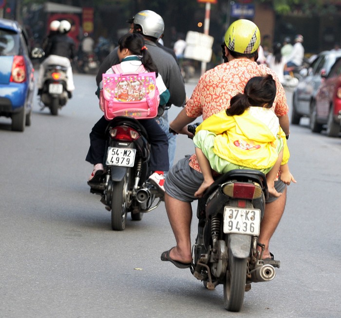 Rất nhiều bé ở độ tuổi 2 – 5, thậm chí nhỏ hơn, được cha mẹ chở đi học bằng xe máy như thế này