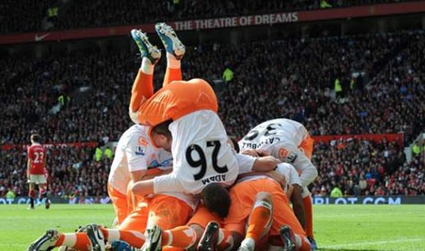 Charlie Adam (Blackpool) với thế lộn người ăn mừng hướng mặt về một đống "bàn tọa" của các đồng đội