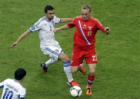Yiannis Maniatis (áo trắng, Hy Lạp) tranh bóng với Denis Glushakov (Nga, áo đỏ).