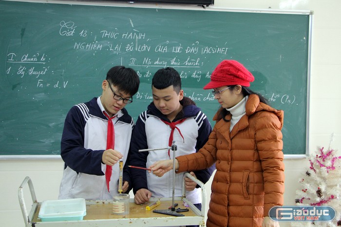 Cô giáo Trịnh Thị Thu Chang cùng học sinh trong giờ thực hành môn Vật Lý (Ảnh: Lã Tiến)