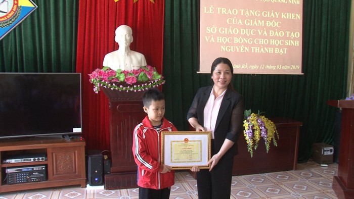 Vũ Thị Liên Oanh, Giám đốc Sở Giáo dục và Đảo tạo tỉnh Quảng Ninh tặng giấy khen và trao học bổng cho em Nguyễn Thành Đạt. (Ảnh: CTV)