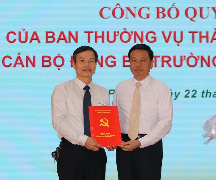 Ông Phạm Văn Hà, Trưởng ban Tổ chức Thành ủy Hải Phòng trao quyết định chuẩn y Bí thư Đảng ủy Trường Đại học Hải Phòng đối với Dương Đức Hùng (bên trái) (Ảnh: CTV)