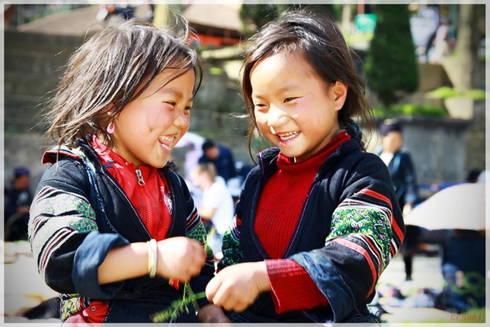 Nụ cười bẽn lẽn của hai bé gái người H'Mong đen ở trung tâm thị trấn Sapa, Lào Cai.