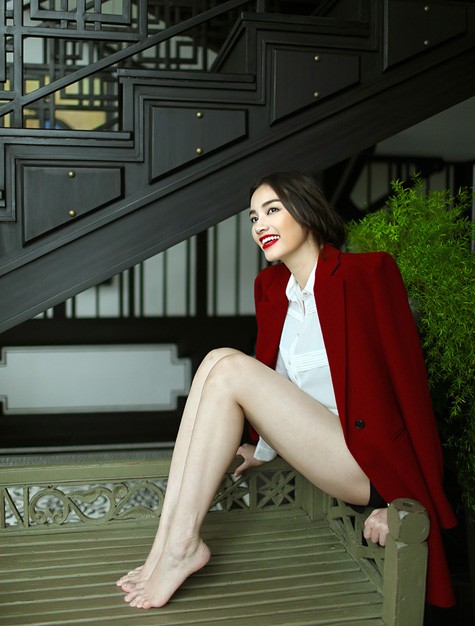 Cô khoe đôi chân trắng ngần và dài miên man với áo khoác đỏ nổi bật