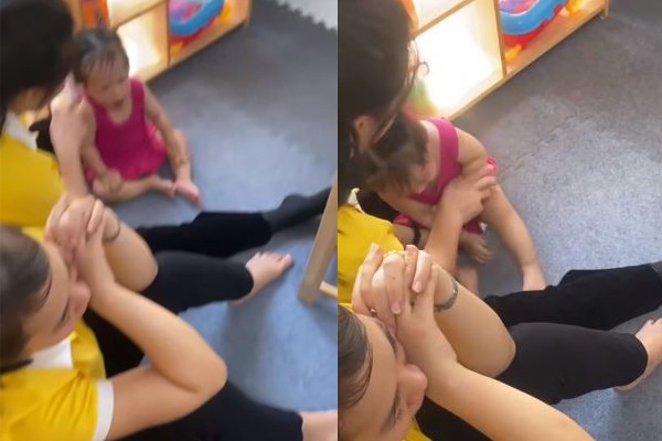 Clip ghi lại hình ảnh nữ giáo viên cơ sở mầm non tư thục Ngôi Sao Nhỏ ấn đầu bóp miệng bé gái 14 tháng tuổi, bên cạnh có một giáo viên khác nhưng không có sự can thiệp. (Ảnh cắt từ clip)